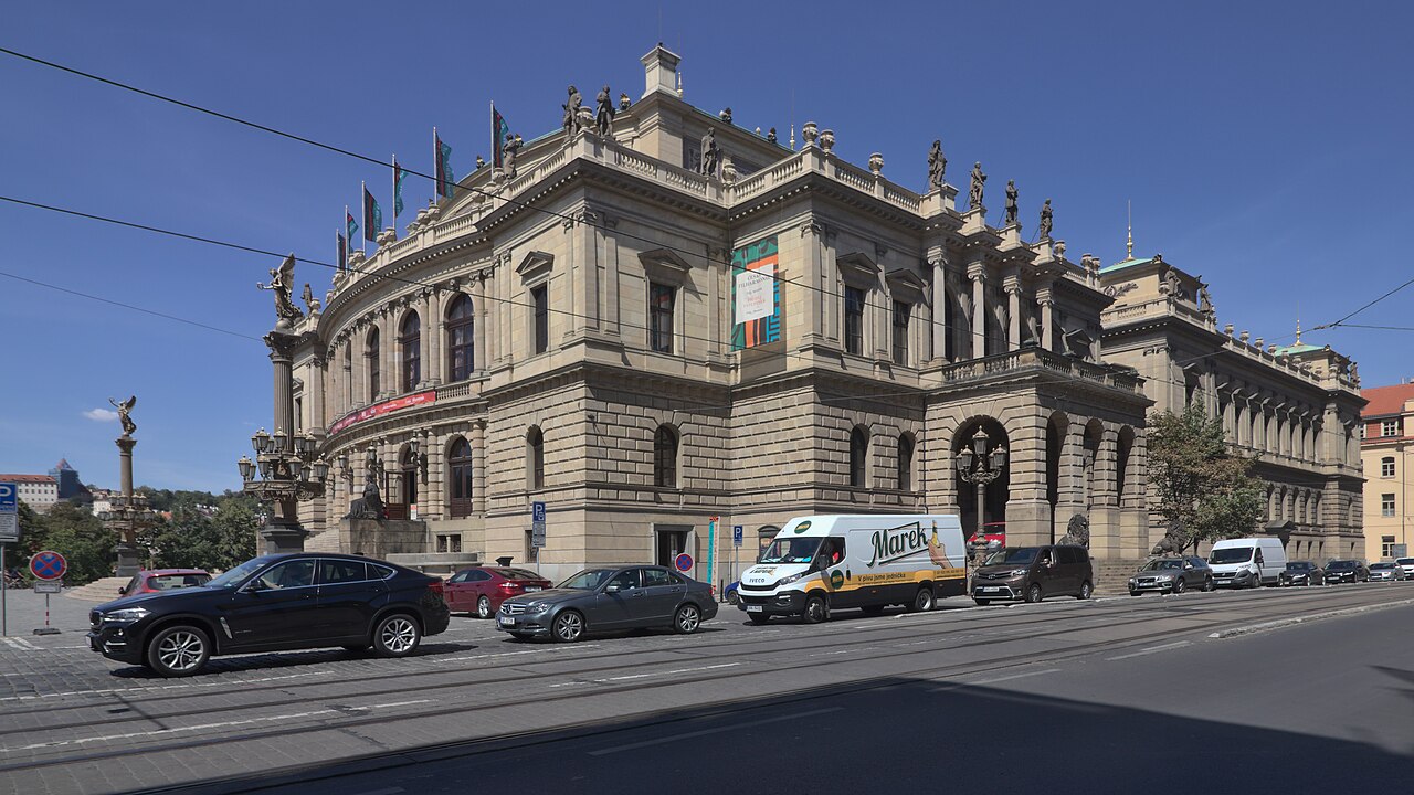 A long concert hall with a columned central pavilion and a balustraded roof.