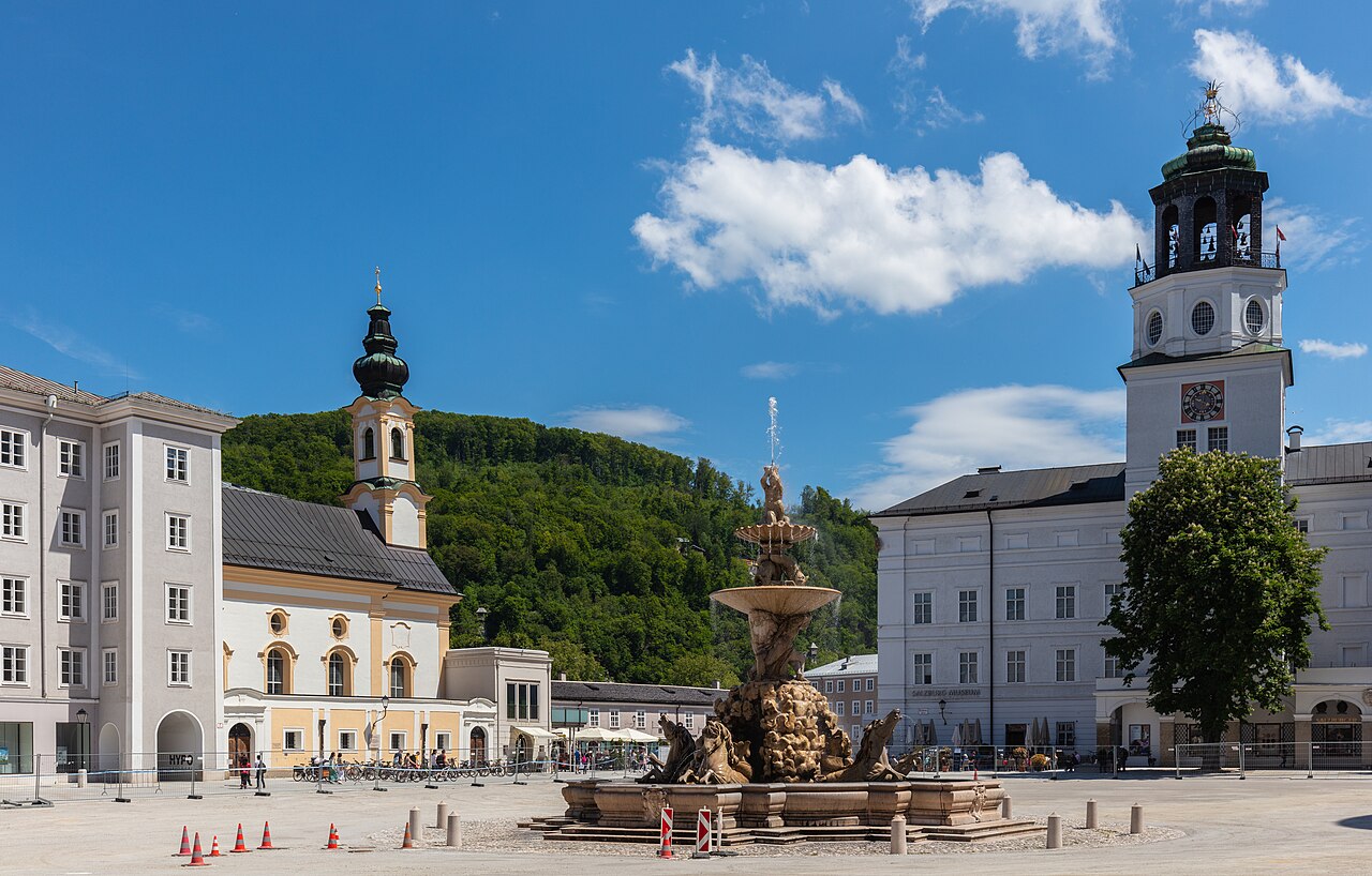 Residenzplatz by day under a blue sky with white clouds
