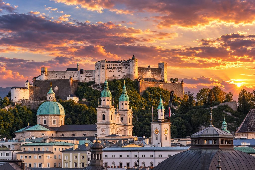 Illustration of Salzburg's old town and fortress at golden hour