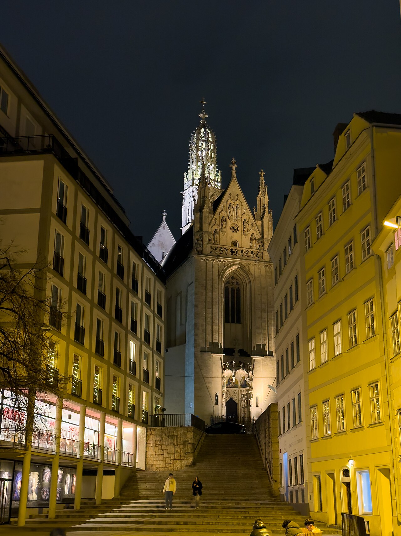 Night view up the steep stone steps (the Marienstiege) to the Gothic west front and openwork spire of Maria am Gestade...