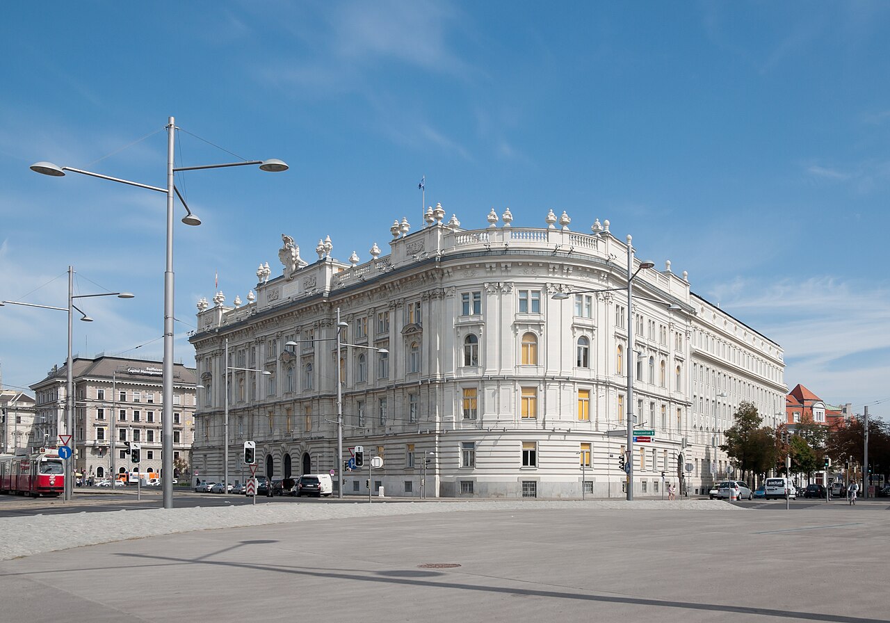 A long neo-Baroque office palace with domed corners and rooftop sculpture.